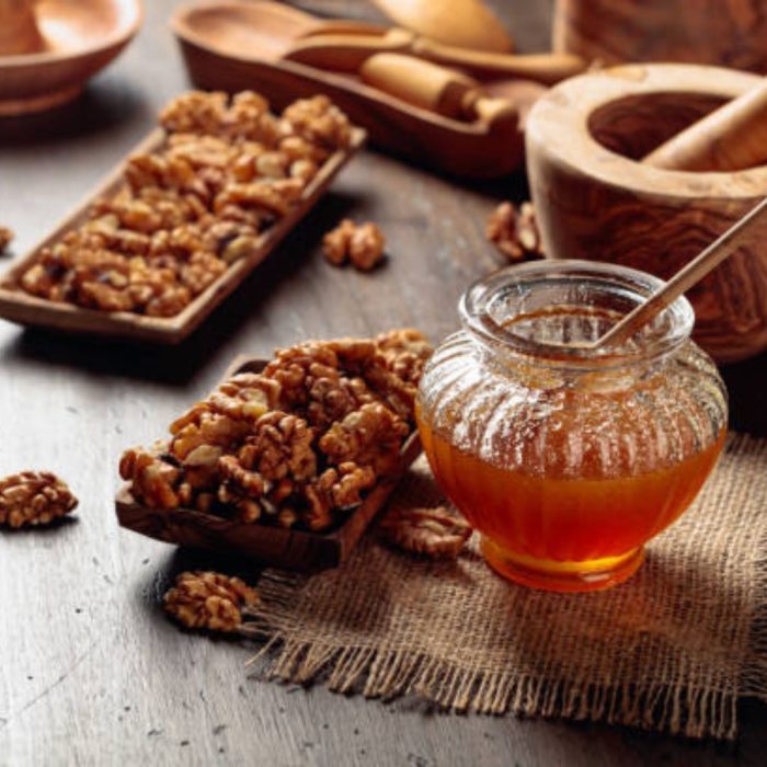 Healthy breakfast background. Honey and walnut on a old wooden table